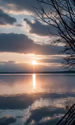 the sun setting in the sky above some water