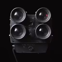 three cameras that are sitting on a black surface