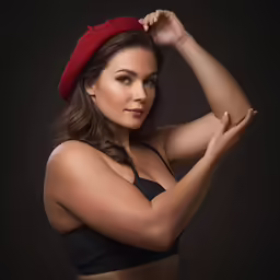 the woman wearing a red hat is posing for the camera