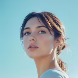a woman with a ponytail, and blue eyes stares up into the sky