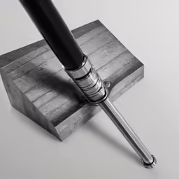 an object made from metal and wood with a metal tip