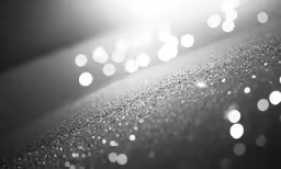 white dots in the light are making bubbles on a surface