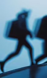 an abstract image of a person walking past a building