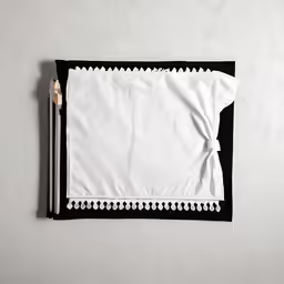 some kind of cloth on a table with a pencil