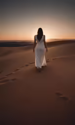 a woman is walking through the sand in front of a sunset