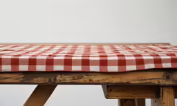 a picnic table with a red and white checked tablecloth