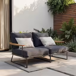 an outdoor couch on the patio is made with wood and fabric