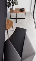 a modern living room with two black and white couches