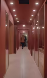 a long narrow corridor with many stalls on either side of it