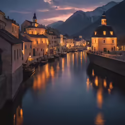 a city is lit up with lights as it reflects the water