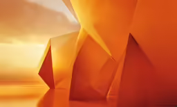 abstract orange design of large white shapes against an orange sunset background