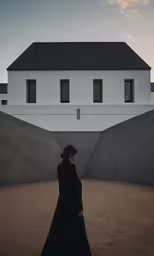 a person standing in front of a house with their back turned to the camera