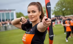 a woman holding two orange and black arrows