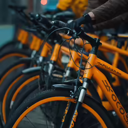 a man riding on the back of a bike in front of other bikes