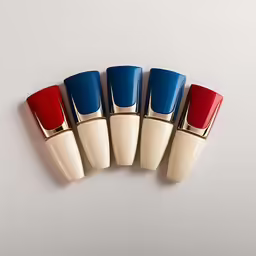 a set of five different colored lipstickes in a row
