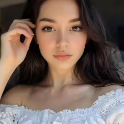 woman in white dress standing by herself and looking at the camera