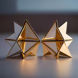 two paper crafts that look like pentagons on the floor