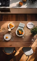 a table is set with a wooden dining table and chairs