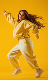a person jumping in the air in a yellow outfit