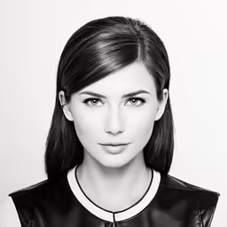 a young woman in black and white looking at the camera