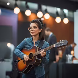 a beautiful young woman holding a guitar in her hands