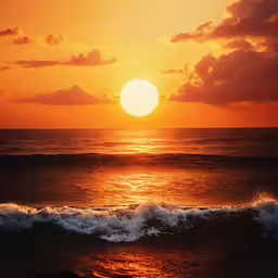 a sunset at the ocean with a wave breaking into the shore
