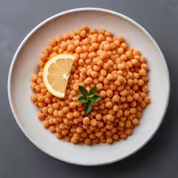 a plate filled with some food and garnished with a slice of lemon