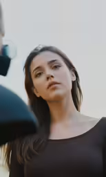 a woman standing in front of a camera next to her