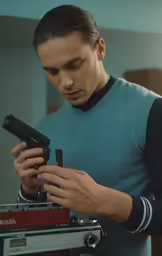 the man is looking at his phone while recording