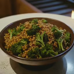 a bowl of food with broccoli and nuts in it