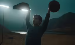 a man holding a basketball at the ball in the air