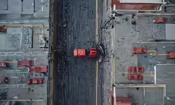 an aerial shot of a parking lot and parking meters