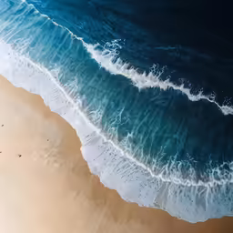 a view of the ocean waves on a sandy beach
