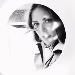 a girl is posing in front of a mirror