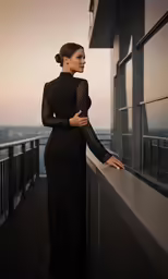 woman wearing long black dress leaning on railing