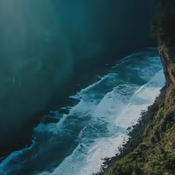 an ocean cliff that looks over to the water