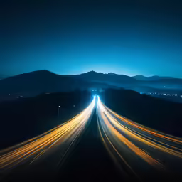 traffic drives down the highway at night time