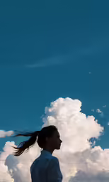 the woman is looking up at the sky and she is flying