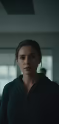 a woman wearing black is standing in a room