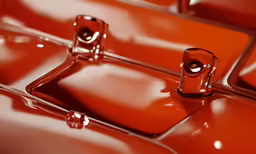 a close up view of red, shiny tiles
