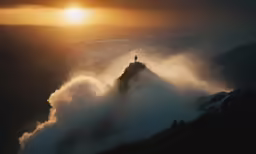 person standing on top of cliff during the sunset
