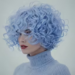 a woman with blue curly hair is photographed