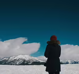 a man that is in the snow with a hat