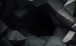 an arrangement of black rocks with one dark one