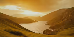 the sun shines over some mountains with small lakes