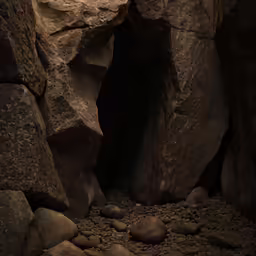 a person sitting on rocks in front of a cave