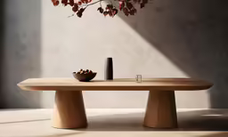 an oval table that has two leaves hanging from the back of it