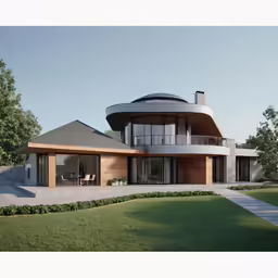 a modern home sits in the grass under a blue sky