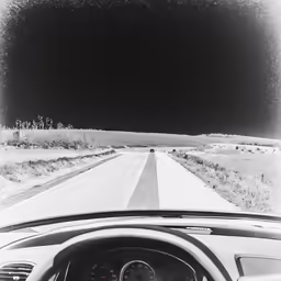 a car is driving down a deserted road