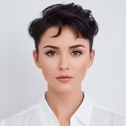 woman with dark hair wearing a white shirt
